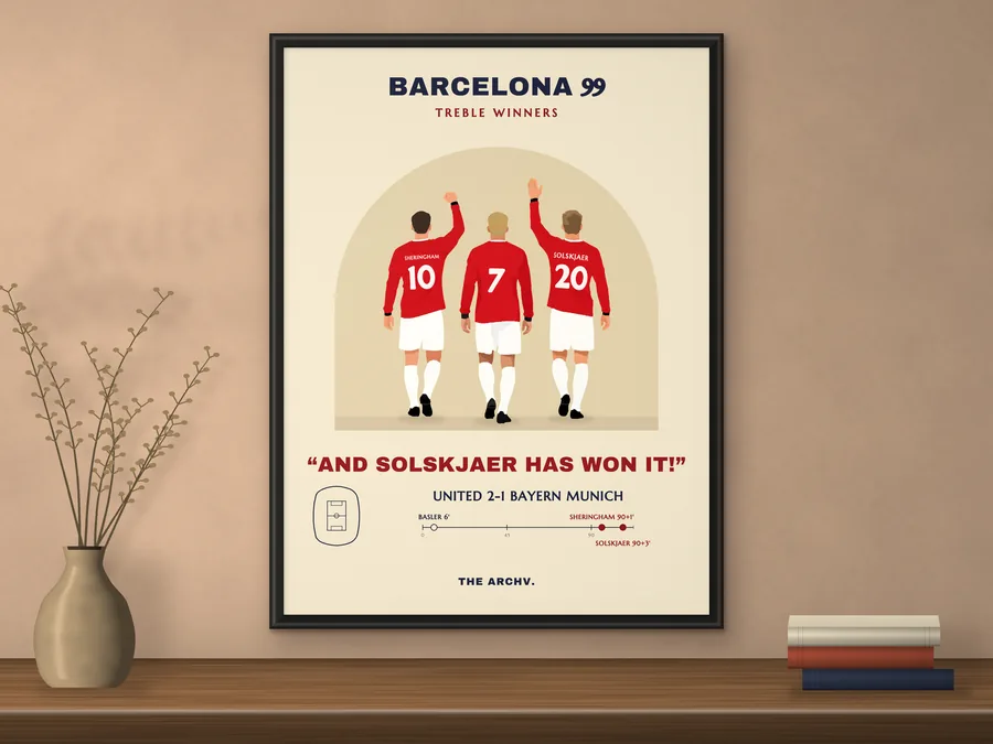 Manchester United 1999 Champions League final poster, Barcelona 99, framed on a shelf.