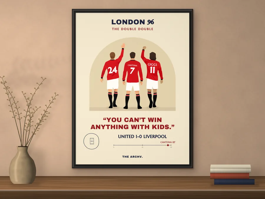 Framed poster of Manchester United 1-0 Liverpool, the 1996 FA Cup final at Wembley, hanging on a wall.