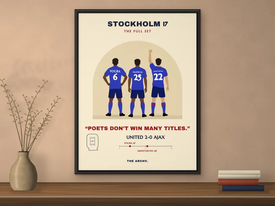 Framed poster of Manchester United 2-0 Ajax, the 2017 Europa League final in Stockholm, hanging on a wall.